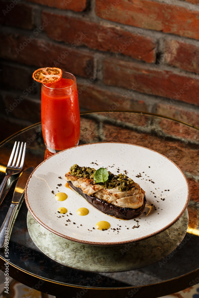 Baked eggplant stuffed with grilled chicken, tomatoes and spices on white plate. Traditional dish Karniyarik of turkish cuisine. View from above