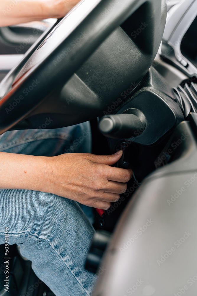 Close up of woman hand starting engine with key. Truck woman driver