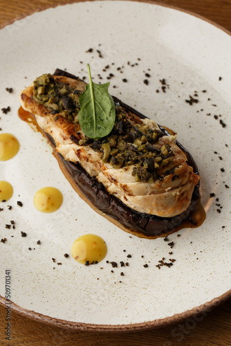 Obraz na płótnie Baked eggplant stuffed with grilled chicken, tomatoes and spices on white plate. Traditional dish Karniyarik of turkish cuisine. View from above w salonie