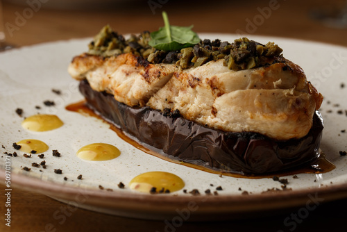Obraz na płótnie Baked eggplant stuffed with grilled chicken, tomatoes and spices on white plate. Traditional dish Karniyarik of turkish cuisine. View from above w salonie