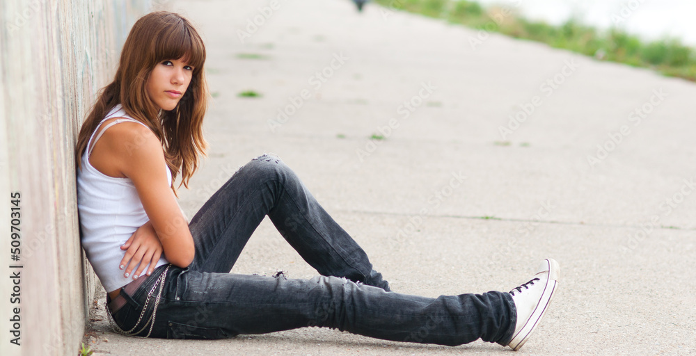 Sad teenage girl sitting alone on the street in summer Stock Photo ...