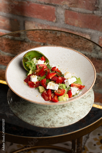 Obraz na płótnie Tasty and healthy salad with arugula, brie cheese, avocado, cherry tomatoes and strawberry. Top view. The flat lay. Banner w salonie