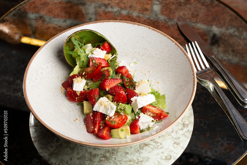Obraz na płótnie Tasty and healthy salad with arugula, brie cheese, avocado, cherry tomatoes and strawberry. Top view. The flat lay. Banner w salonie