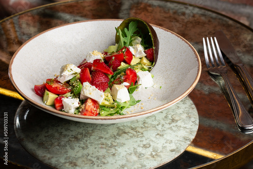 Obraz na płótnie Tasty and healthy salad with arugula, brie cheese, avocado, cherry tomatoes and strawberry. Top view. The flat lay. Banner w salonie