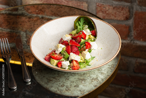 Obraz na płótnie Tasty and healthy salad with arugula, brie cheese, avocado, cherry tomatoes and strawberry. Top view. The flat lay. Banner w salonie