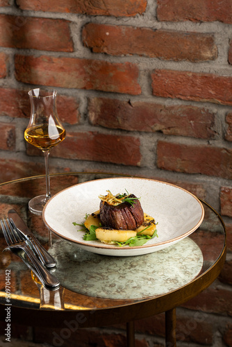 Obraz na płótnie Grilled meat fillet steak medallion with green sauce, served with pear or apple. On dark background w salonie