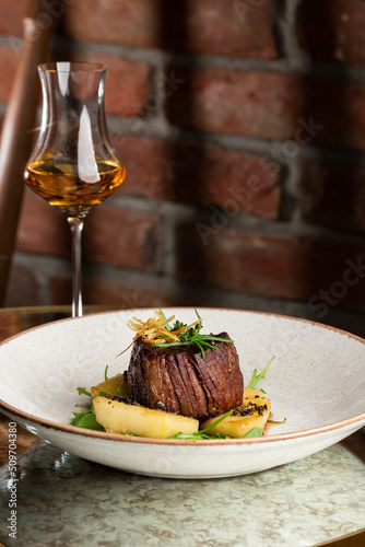 Obraz na płótnie Grilled meat fillet steak medallion with green sauce, served with pear or apple. On dark background w salonie