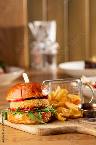 Obraz na płótnie Big cheeseburger with french fries. Hamburger with beef patty onion, tomato, lettuce pickles, melted cheddar, mustards, tomato jam, mayo w salonie