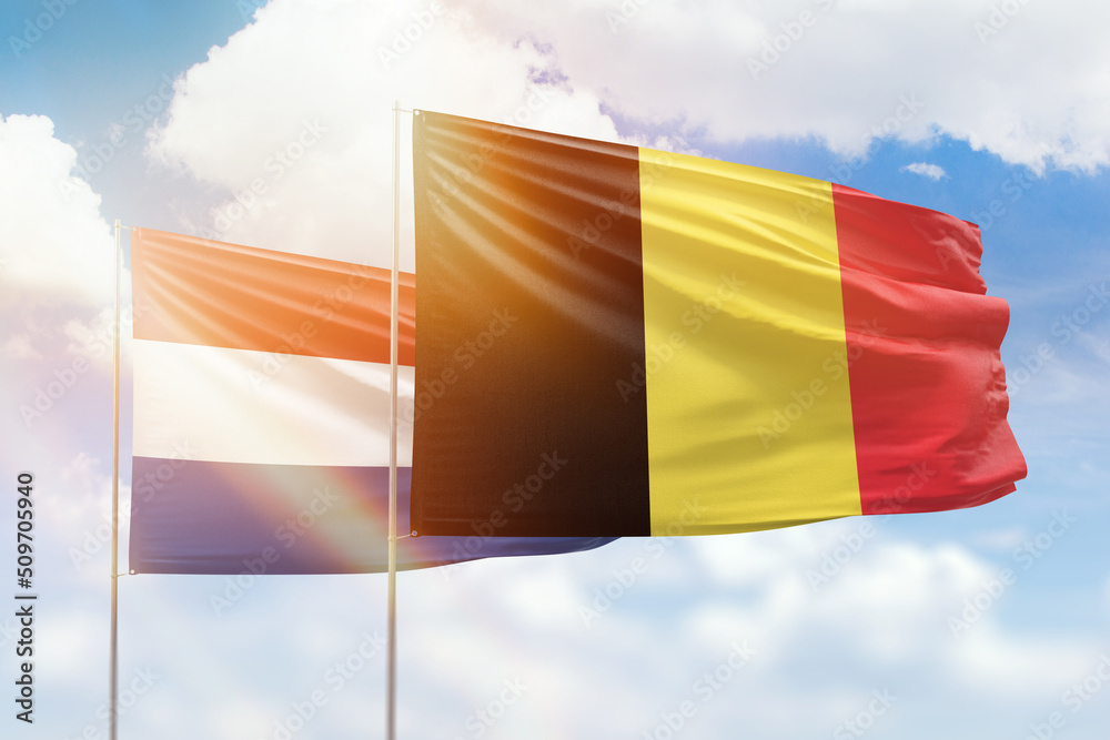 Sunny blue sky and flags of belgium and netherlands - obrazy, fototapety, plakaty 