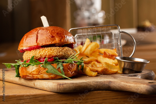 Obraz na płótnie Big cheeseburger with french fries. Hamburger with beef patty onion, tomato, lettuce pickles, melted cheddar, mustards, tomato jam, mayo w salonie