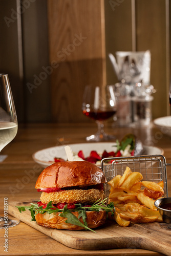 Obraz na płótnie Big cheeseburger with french fries. Hamburger with beef patty onion, tomato, lettuce pickles, melted cheddar, mustards, tomato jam, mayo w salonie