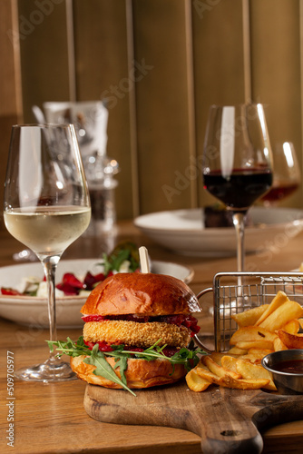 Obraz na płótnie Big cheeseburger with french fries. Hamburger with beef patty onion, tomato, lettuce pickles, melted cheddar, mustards, tomato jam, mayo w salonie