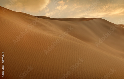 Panorama of sand dunes Sahara Desert at sunset. Endless dunes of yellow sand. Desert landscape Waves sand nature