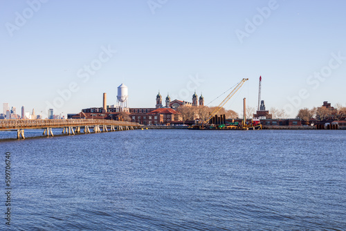 Jersey City, New Jersey, USA - December 22 2021: Ellis Island National Museum of Immigration. View from Statue of Liberty State Park.