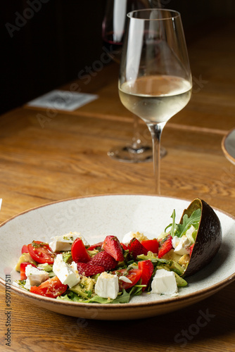 Obraz na płótnie Tasty and healthy salad with arugula, brie cheese, avocado, cherry tomatoes and strawberry. Top view. The flat lay. Banner w salonie