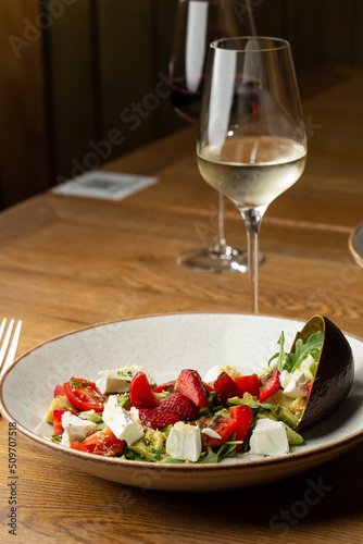 Obraz na płótnie Tasty and healthy salad with arugula, brie cheese, avocado, cherry tomatoes and strawberry. Top view. The flat lay. Banner w salonie