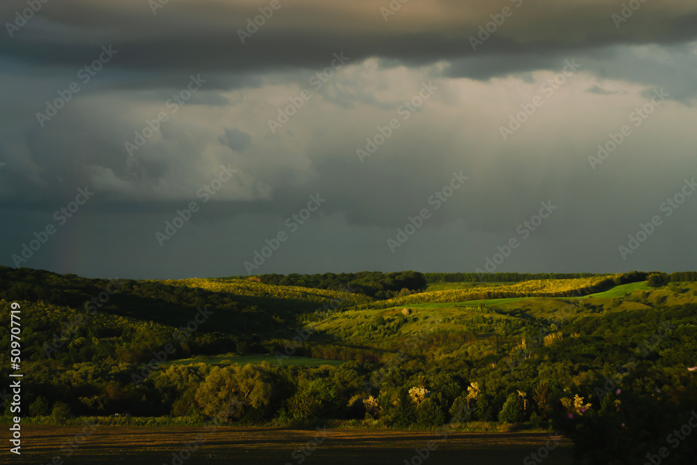 Obraz premium The sky after a thunderstorm on a summer evening in the rays of the sun