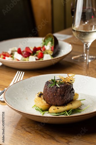 Obraz na płótnie Grilled meat fillet steak medallion with green sauce, served with pear or apple. On dark background w salonie