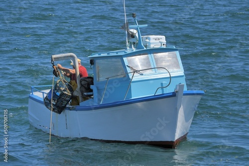 Fisherman on his boat fishing crustaceans in Brittany France © aquaphoto