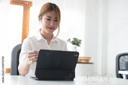 A young Asian lady is sitting at the table