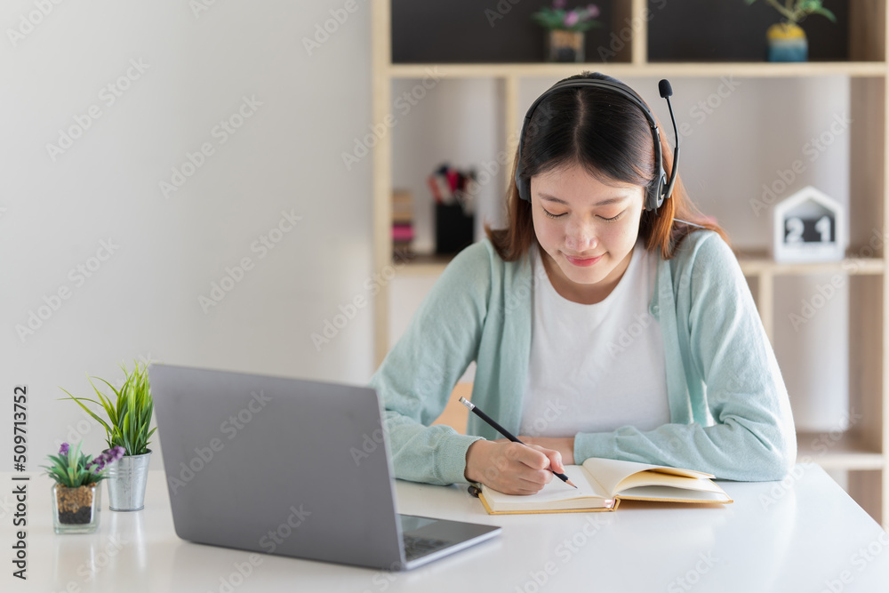 E-learning ,online ,education and internet social distancing protect from COVID-19 viruses concept. Asian woman student video conference e-learning with teacher on laptop computer at home. E-learning ,online ,education and internet social distancing protect from COVID-19 viruses concept. Asian woman student video conference e-learning with teacher on laptop computer at home.