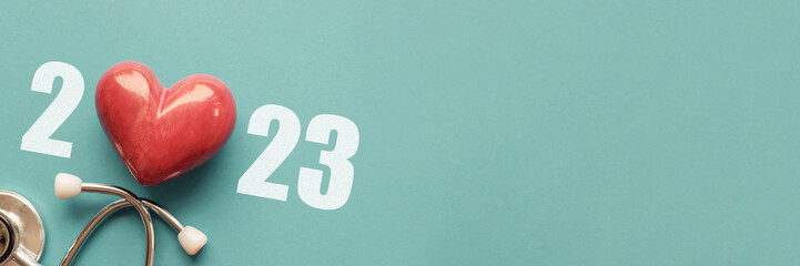 2023 with Red heart nad stethoscope, heart health,  health insurance concept, new year resolutions goal