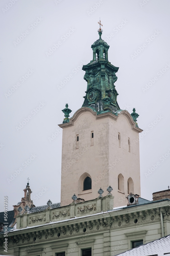 High tower of the Latin Cathedral of the Assumption of the Virgin Mary in Lviv. Historical part of the city, view from below against the blue sky.