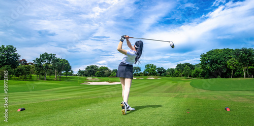 Professional woman golfer teeing golf in golf tournament competition at golf course for winner 