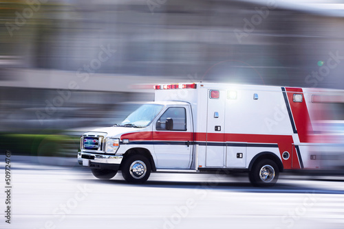 Blurred motion action view of an ambulance responding to the scene of an emergency. photo