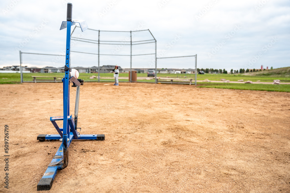 Mechanical youth slow pitching machine used to throw a baseball for batting 