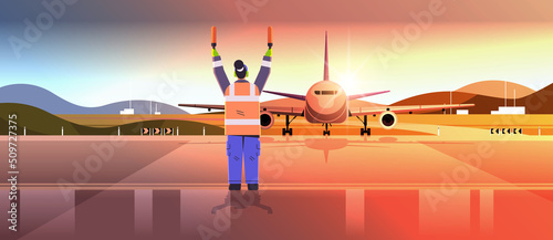 aviation marshaller supervisor in uniform navigate with light sticks air traffic controller airline worker in signal vest