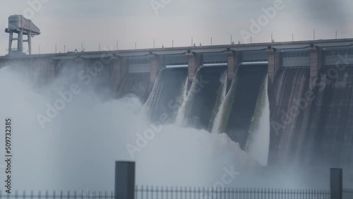 Hydroelectric dam top view. Discharge of water at hydroelectric power plants. Big waterfall. Electricity. Krasnoyarsk hydroelectric power station. Yenisei river.