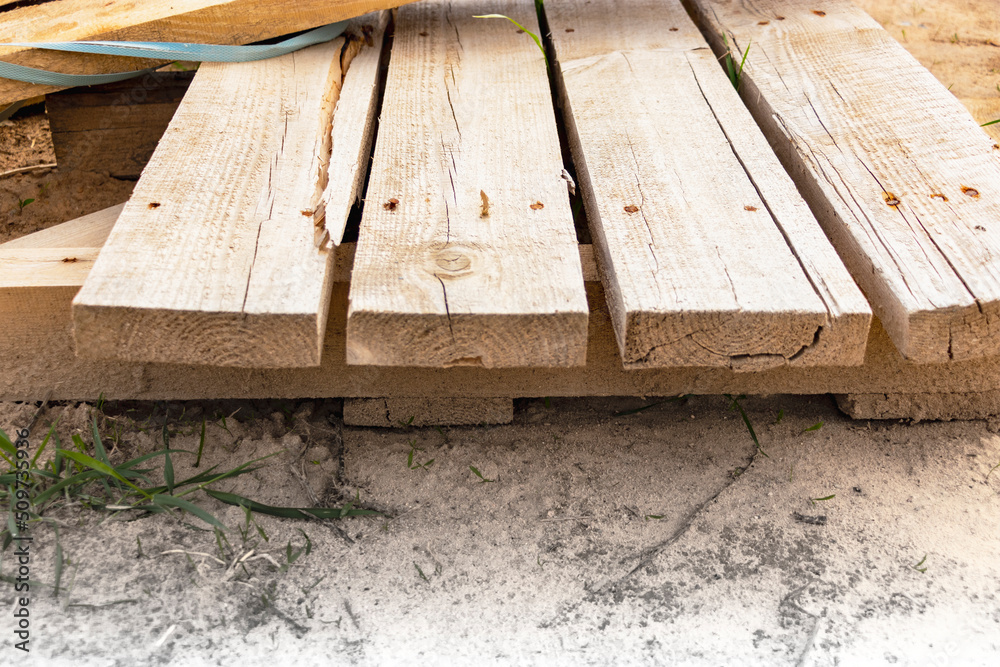 Wooden pallet close-up at a construction site. Reuse of wooden pallets. Wooden pallet close-up at a construction site. Reuse of wooden pallets.