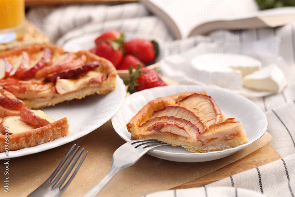 Apple pie and different products on blanket, closeup. Summer picnic Apple pie and different products on blanket, closeup. Summer picnic