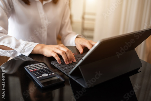 Businesswoman hand using laptop  tablet and smartphone  in office. Digital marketing media mobile app