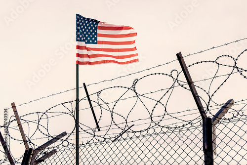 mexican border. Concept of United States of America closed borders with flag and wire fence. USA immigration and homeland security. American dream concept, not accessible and hard to reach.