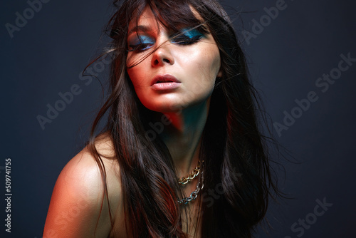 Beautiful woman in color Light. amazing girl with colorful makeup