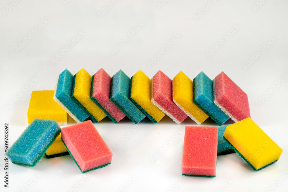 Colorful sponges with an abrasive bright white layer for washing dishes and other household or domestic needs. Colorful sponges with an abrasive bright white layer for washing dishes and other household or domestic needs.