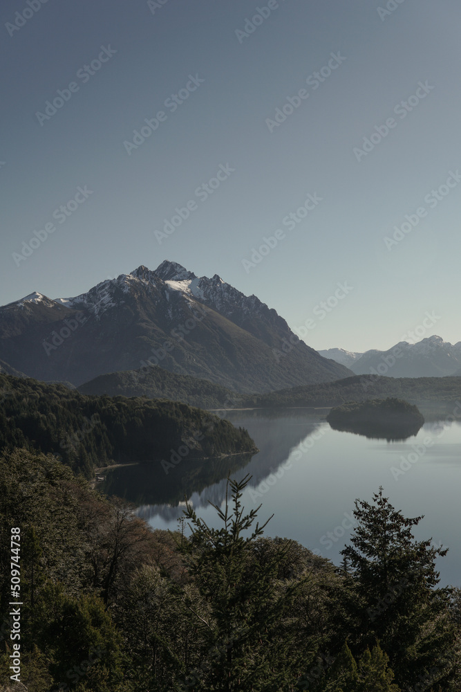mirrored lake, forests and snow-capped mountains in San Carlos de Bariloche, Argentina