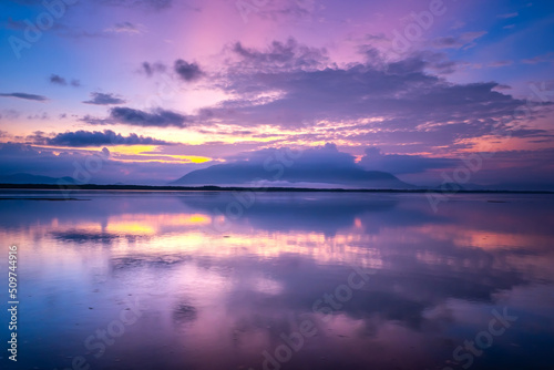 Beautiful sunset or sunrise with dramatic sky clouds over calm sea in tropical Koh Phra Thong island, Phang Nga. Amazing nature view and light of nature.