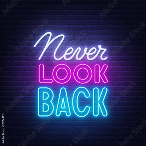Never Look Back neon sign on brick wall background.