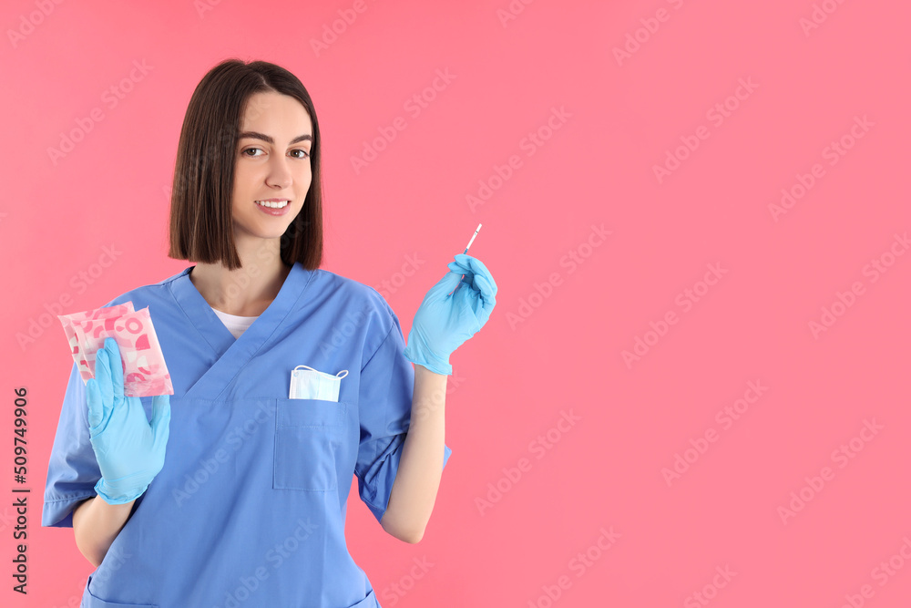 Attractive young female doctor on pink background Attractive young female doctor on pink background
