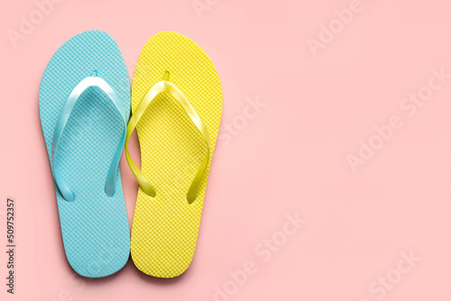 Summer holiday concept.Top view of colored beach flip flops with space for tex