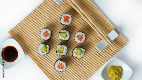 Sushi composition with salmon, avocado and cucumber. Sushi roll on a white background.