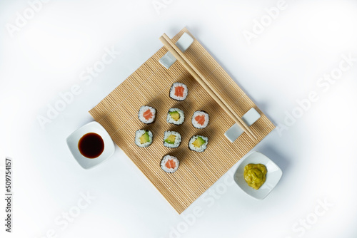 Sushi composition with salmon  avocado and cucumber. Sushi roll on a white background.