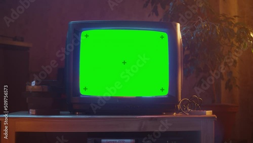 Close Up Footage of a Dated TV Set with Green Screen Mock Up Chroma Key Template Display. Nostalgic Retro Nineties Technology Concept.