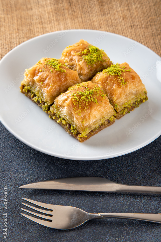 Pistachio baklava on a white plate Pistachio baklava on a white plate
