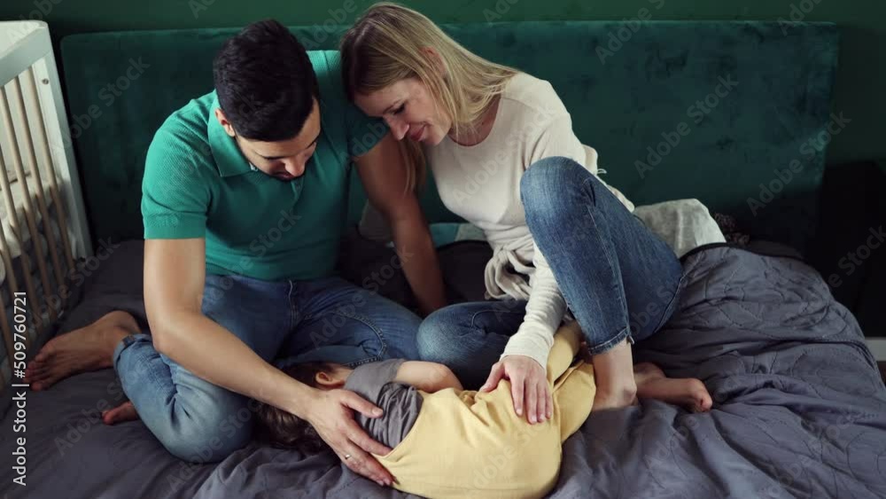 Young parents playing with their child at home
Young parents playing with their child at home