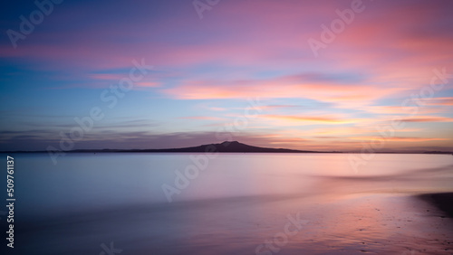 Milford Beach at dawn with Rangitoto Island in the distance, Auckland.