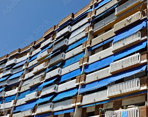 Typical house with sun protection awnings against the summer heat in Spain photo